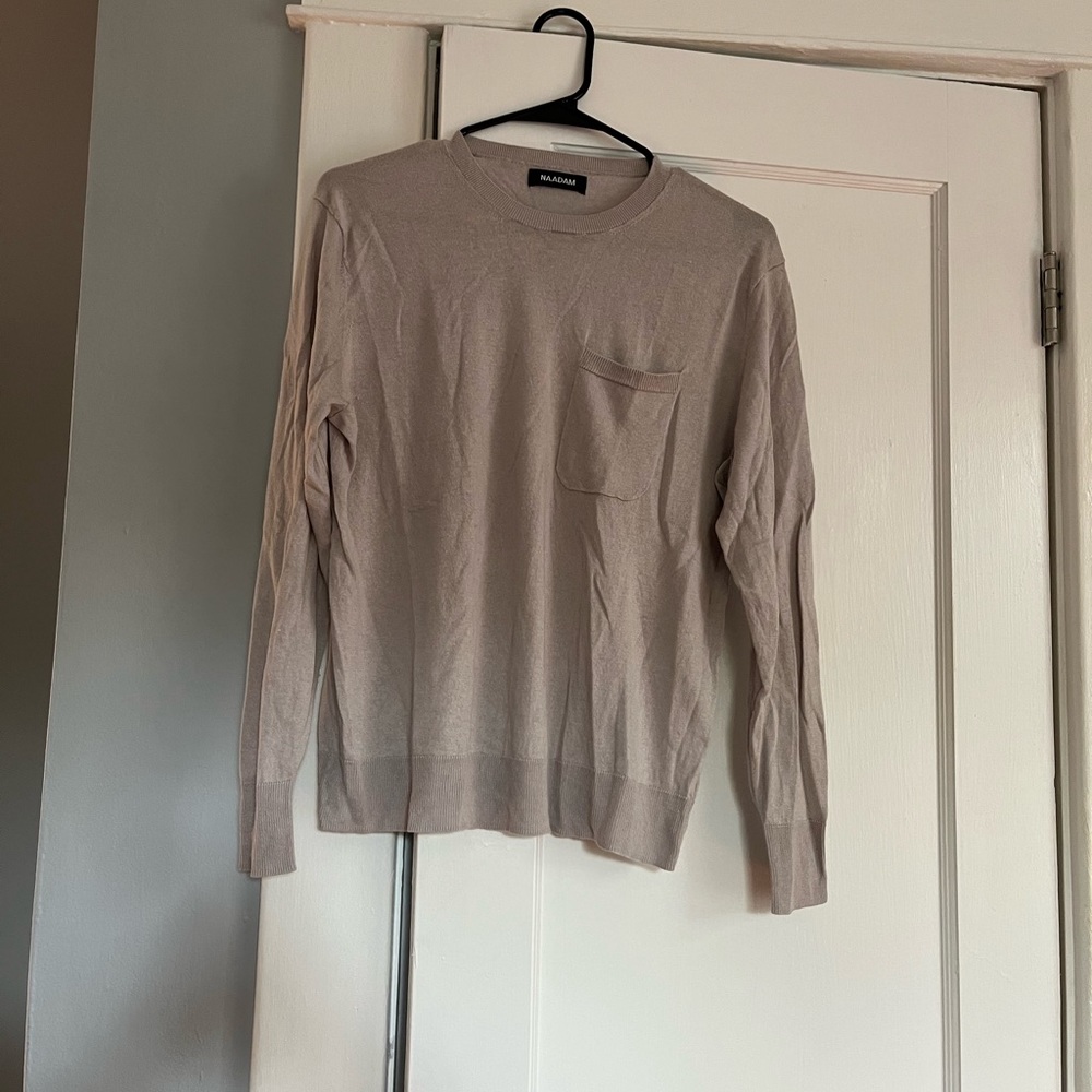 Grey/purple knit top with pocket.